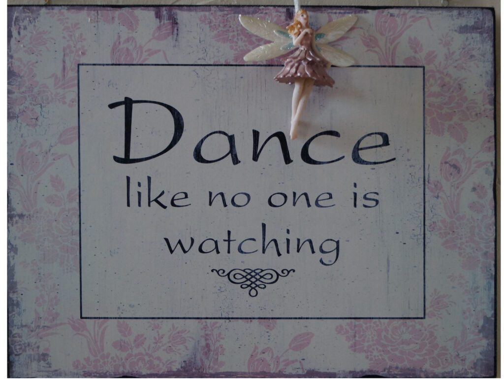 sign saying dance like no one is watching